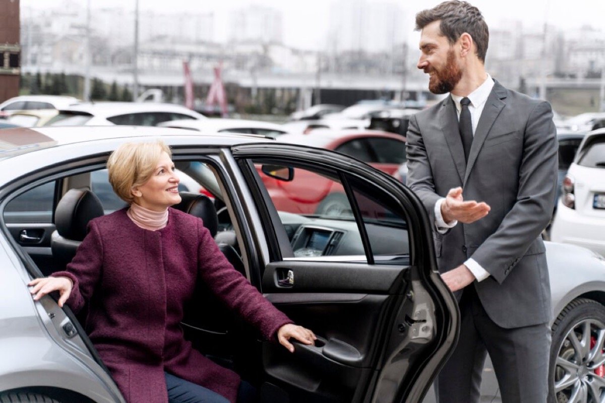 Professional AZ Private Chauffeur greeting a passenger with warm hospitality at vehicle door