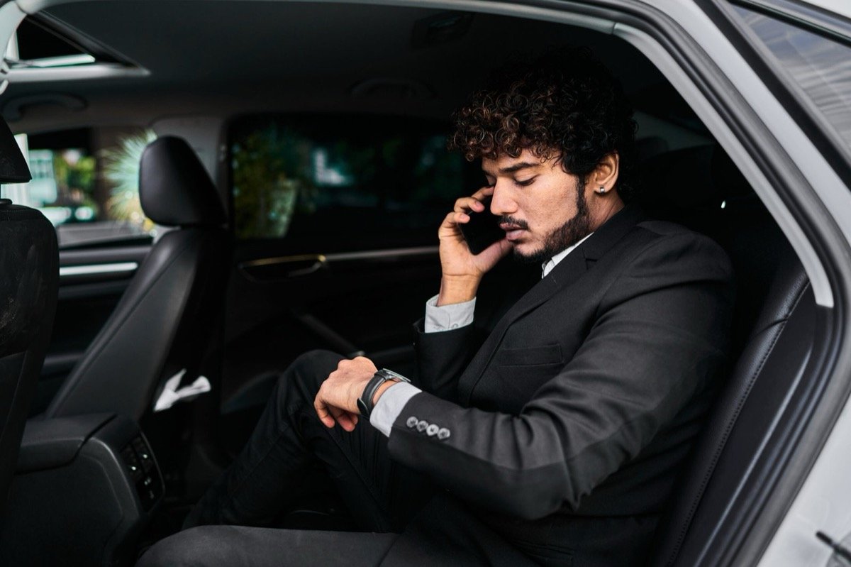 Passenger relaxing comfortably in luxury leather backseat during Scottsdale chauffeur trip